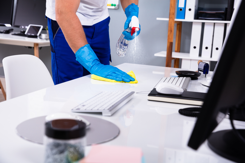 wiping in between keyboards on top of office table