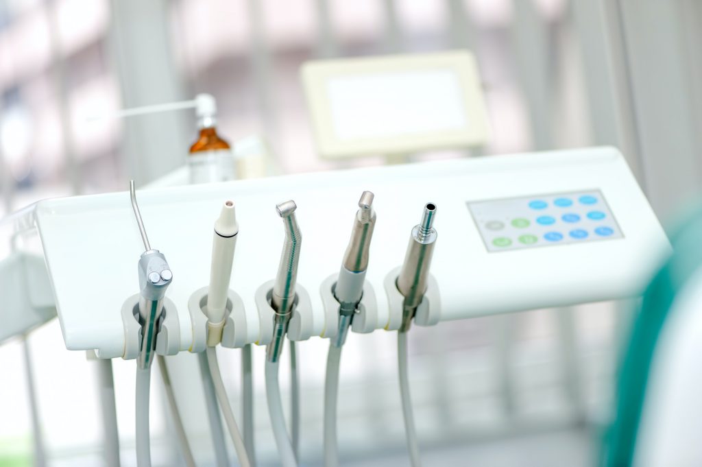 Dental tools on a dentist's chair with white background