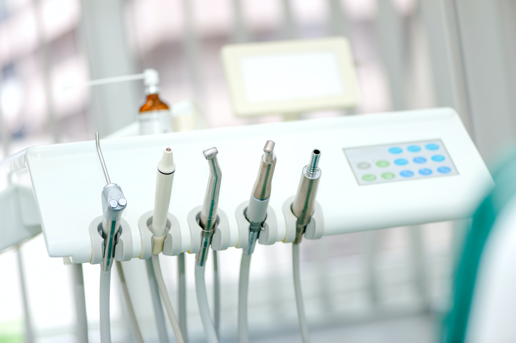 Dental tools on a dentist's chair with white background