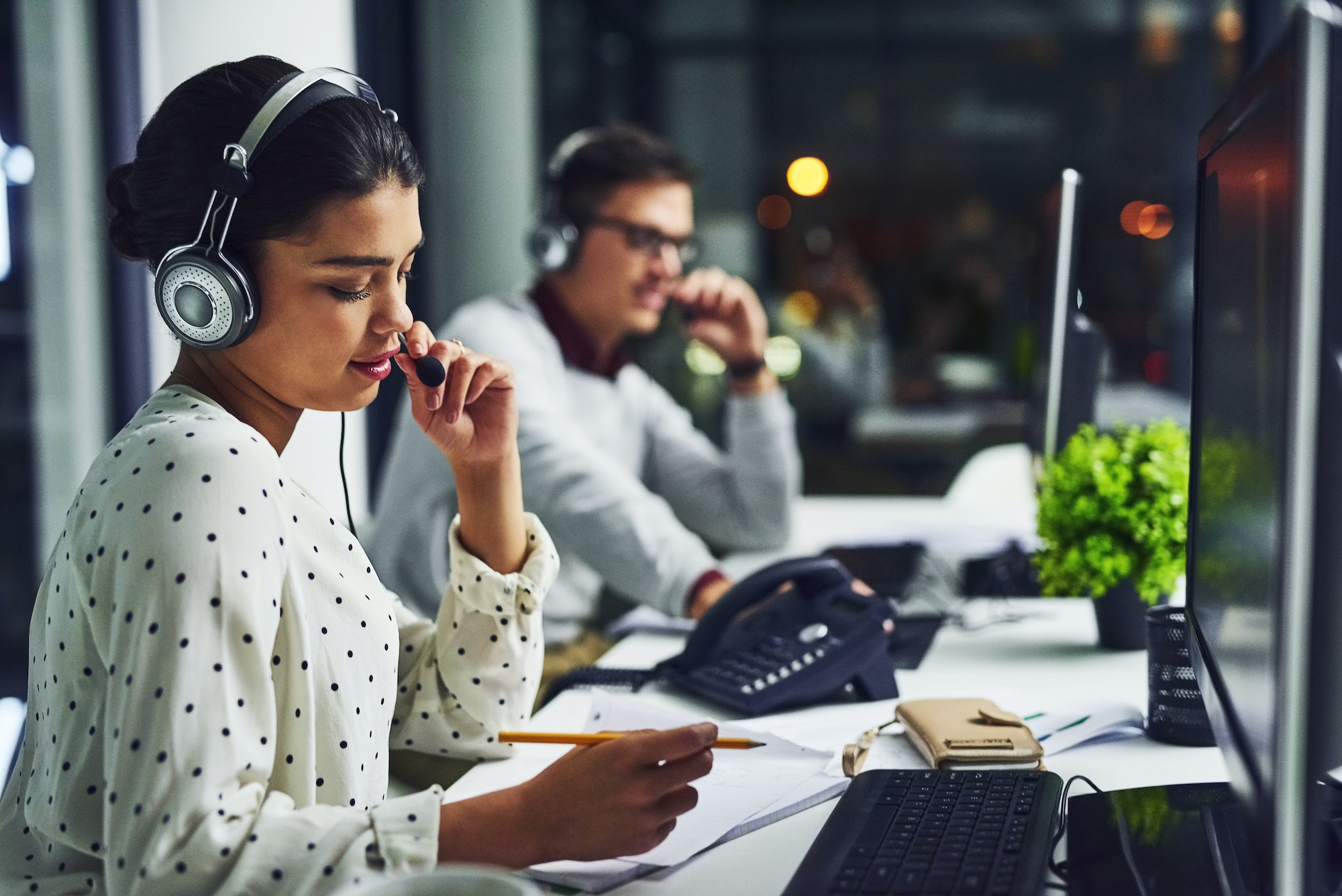 Shot of young call centre agents working late in an office